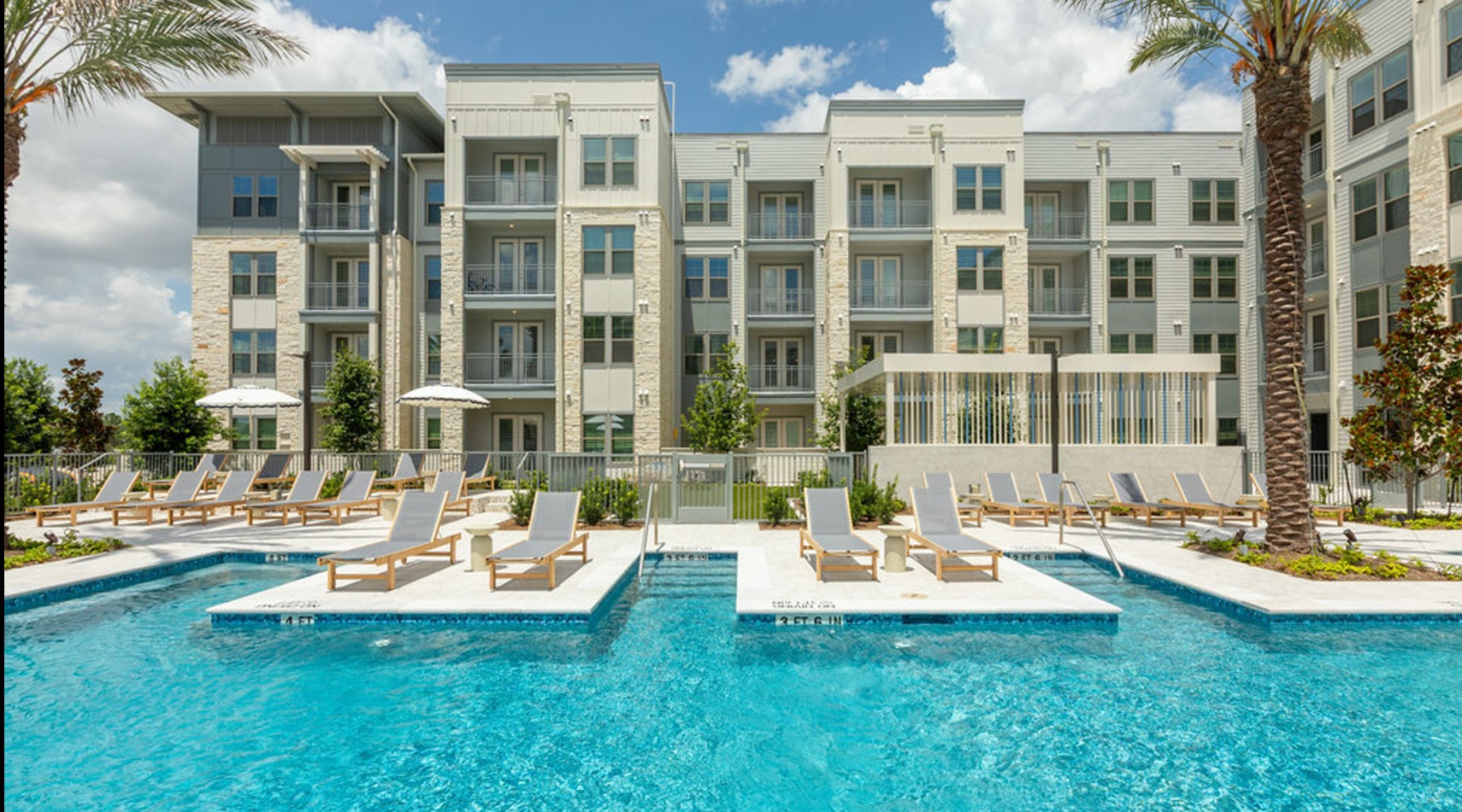 a swimming pool with lounge chairs