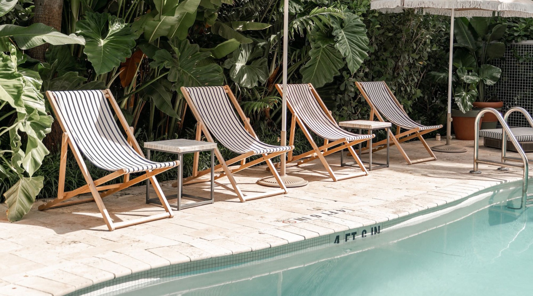 a swimming pool with lounge chairs